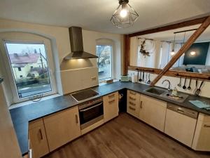 a kitchen with a sink and a stove at Apartment Selina in Lichtenhain