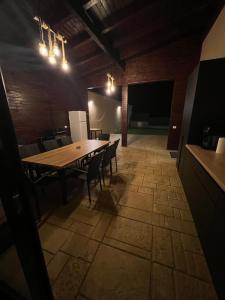 a dining room with a wooden table and chairs at IUNIk in Azuga