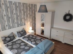 a bedroom with a bed and a dresser and a mirror at Apartment Selina in Lichtenhain