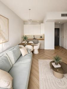 a living room with a couch and a table at Nad Zatoką Apartament 340 in Olsztyn