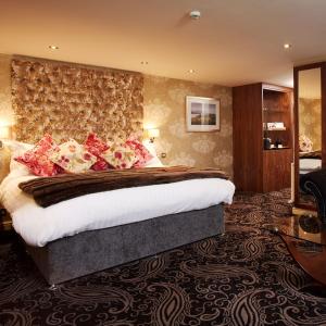 a bedroom with a large bed in a room at Winteringham Fields in Winteringham