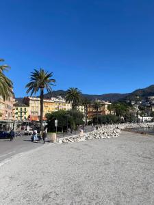 a group of people walking on a street next to the water at Casa di Sara in Rapallo