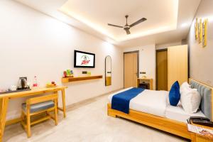 a bedroom with a bed and a desk and a table at Hotel teara in Gwalior