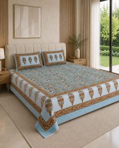 a bedroom with a large bed with pillows at Hotel teara in Gwalior