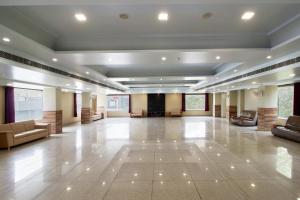 a large lobby with couches and a stage at Treebo Prem Tower in Haldwāni