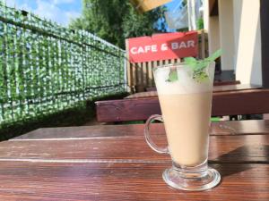 a glass of coffee and bar sitting on a table at Hotel Eden 24h in Rzeszów