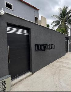 a pair of garage doors on the side of a building at Maria Lofts in Itaguaí +4 photos