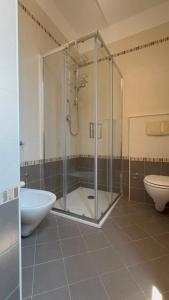 a bathroom with a shower and a tub and a toilet at Suite 93 in Mola di Bari