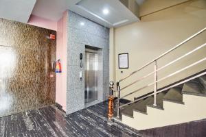 a hallway with stairs and a stair case at Treebo Prem Tower in Haldwāni