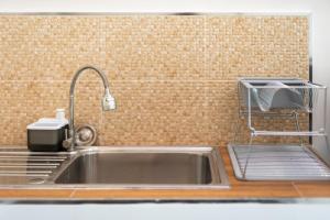 a kitchen sink with a faucet next to a brick wall at Turtle Tales-Tao Khon in Thai Muang +48 photos