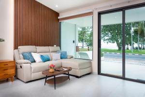 a living room with a couch and a table at Turtle Tales-Tao Khon in Thai Muang