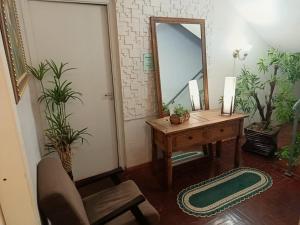 a room with a desk and a mirror and a chair at Hotel Central in Arroio do Meio