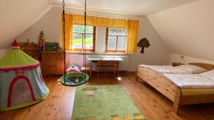 a bedroom with two beds and a play tent at Ferienhof Heufelder Hof in Ehrenberg