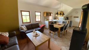 a living room with a couch and a table at Ferienhof Heufelder Hof in Ehrenberg
