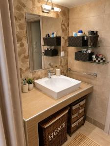 a bathroom with a sink and a mirror at The Secret Garden Peraia in Perea +14 photos