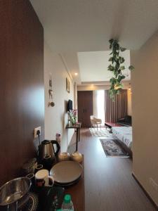 a room with a kitchen and a living room at Sunlit Omaxe ITC, Greater Noida in Greater Noida