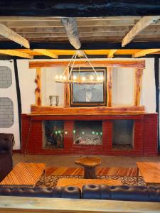 a large room with a fireplace and a television at EarthShip Log Cabin, Timau in Nanyuki