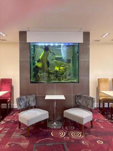 a room with a fish tank on the wall at ICON Hotel in Luton
