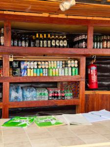 a room with a shelf filled with lots of drinks at EarthShip Log Cabin, Timau in Nanyuki