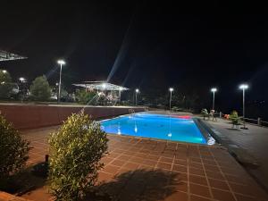 an empty swimming pool at night with lights at Senmonorom in Senmonorom