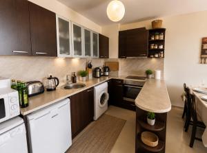 a kitchen with a sink and a dishwasher at Spacious 2 bedroom apartment in Balchik