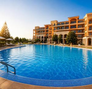 a large swimming pool in front of a building at Spacious 2 bedroom apartment in Balchik