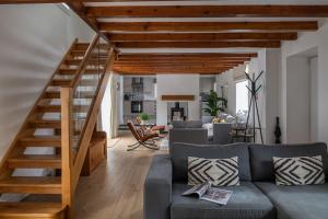 a living room with a staircase and a couch at Bayholme House in Oxwich