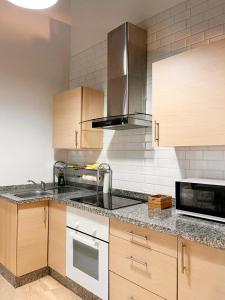 a kitchen with a sink and a microwave at Loft Boutique con Encanto in Montilla