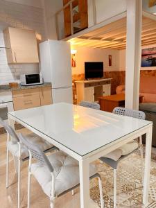 a kitchen with a white table and chairs at Loft Boutique con Encanto in Montilla