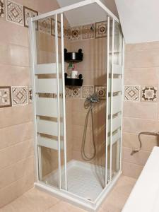 a shower with a glass door in a bathroom at Loft Boutique con Encanto in Montilla