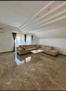 a large living room with a couch and a table at SAN Apartments Near Belgrade Airport in Surčin +16 photos