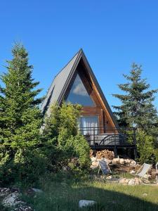 a cabin in the woods with a large window at Horizons by PeaksView Chalets in Žabljak