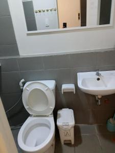 a bathroom with a toilet and a sink at spacious condo unit 1P olvera residences in Bacolod +9 photos
