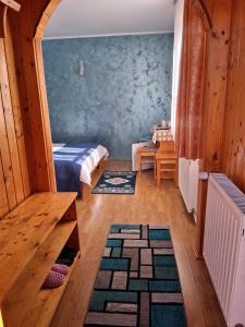 a room with a bed and a table and a rug at Casa Lav in Sinaia