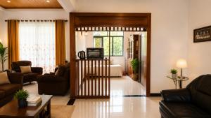 a living room with a couch and a television at The Kandyan Nest in Kundasale