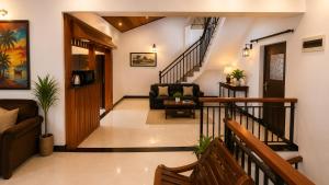 a living room with a staircase with a couch at The Kandyan Nest in Kundasale