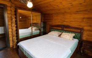 a bedroom with a bed in a log cabin at Дом рыбака Маяки Ватер Сити Днестр in Mayaki