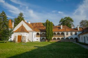a large white house with a green yard at Polixenia Culinary Estate 