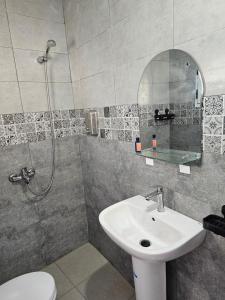 a bathroom with a sink and a shower and a toilet at Chambre d'hôte plage Dalia in Dalia