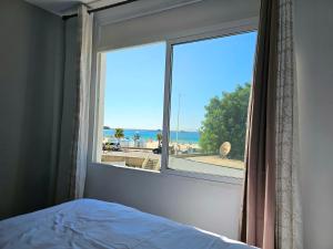 a bedroom with a window with a view of the beach at Chambre d'hôte plage Dalia in Dalia