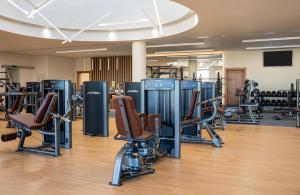 a gym with chairs and machines in a room at InterContinental Amman Jordan by IHG in Amman