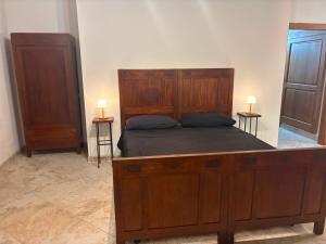 a bedroom with a large wooden bed and two dressers at Al Casolare in Tuoro sul Trasimeno +40 photos