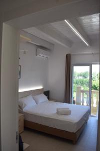 a bedroom with a bed and a large window at Hotel Incontro in Peschici +36 photos