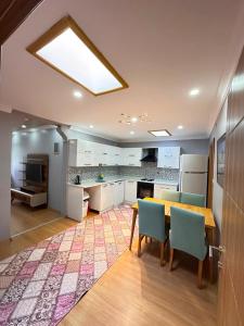 a kitchen with a table and chairs in a room at Koç Motel in Uzungöl