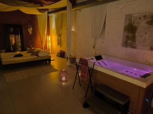 a room with a bath tub with a bed at iRelax studio - privatni wellness in Prague