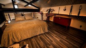 a bedroom with a large bed and wooden floors at Maison LOVEROOM 70m2 L'entre Nous in Grenoble