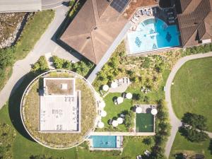 an aerial view of a house with a pool at Resort Hof Weissbad in Weissbad