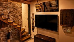 a large flat screen tv hanging on a wall at Maison LOVEROOM 70m2 L'entre Nous in Grenoble