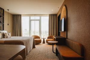 a hotel room with a bed and a television at Van der Valk Hotel Woerden in Woerden