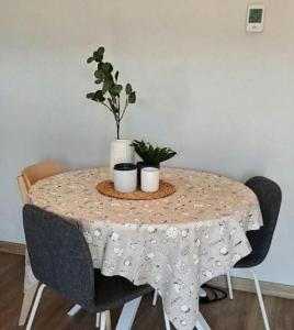 a table with two plants on top of it at Where Mediterranean colours meets you in Terrassa +3 photos